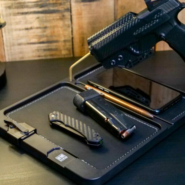 Premium EDC Dump Tray in black with pocket knife, spare magazine and handgun on the brass rod.