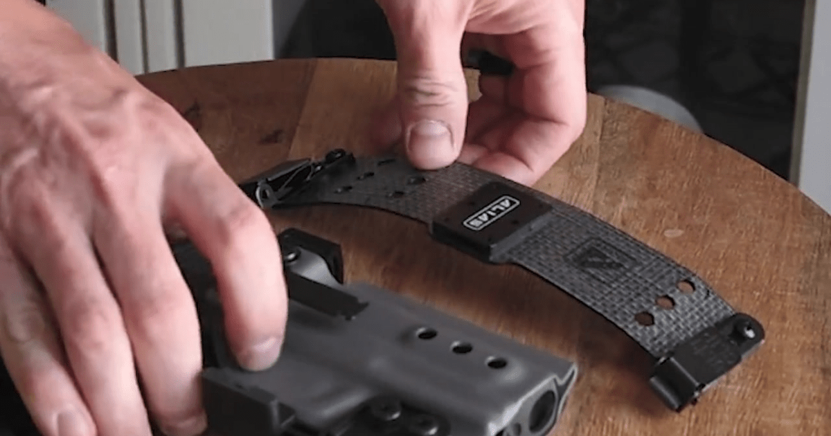A man placing his NeoMag Alias IWB EDC holster on a table.