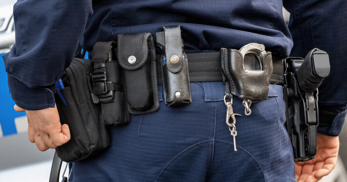 A police officer adjusting his duty belt setup.