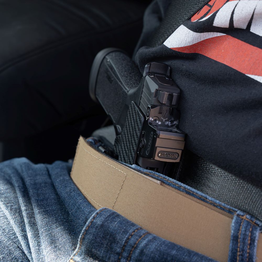 man with appendix carry using the Alias Belt seated in vehicle.