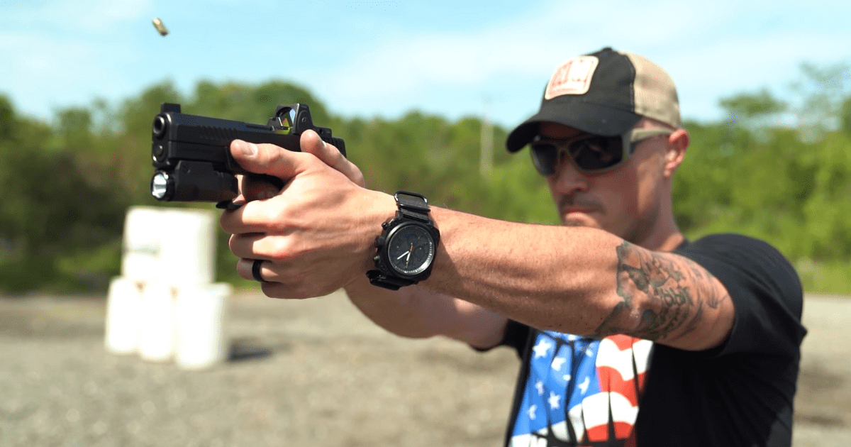 A man wearing a black hat pointing a gun.